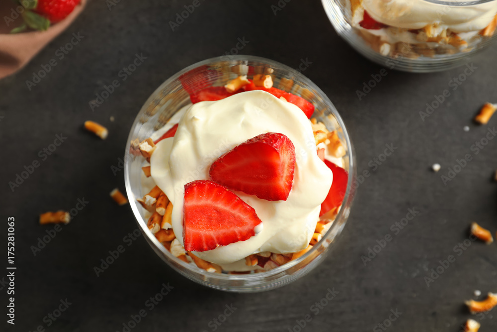 Glass with strawberry pretzel salad on table