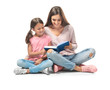 © Africa Studio - Young woman and her little daughter reading book on white background