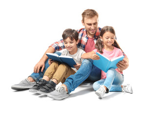 Wall Mural - Young man and his little children reading books on white background