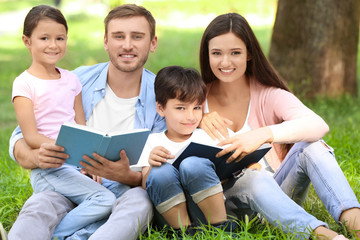 Sticker - Happy family reading books in park