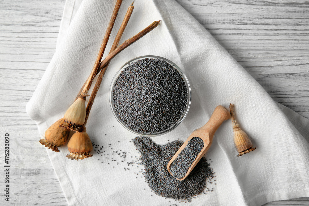 Composition with poppy seeds and dried pods on fabric