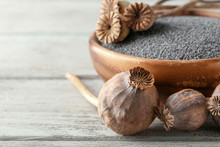 Poppy Seeds And Dried Pods On Wooden Background