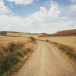 © Luca Pierro/Stocksy - Cloudy sky over golden fields