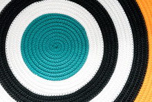 Close Up Circular Pattern Of Woven Fabric Rug.
