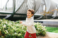 Smiling Little Boy Running In The Park.