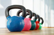 © polack - Colorful kettlebells in a row in a gym