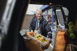 © dglimages - Events businessman is filling his car with props for a client.