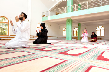 Wall Mural - Muslim man and woman praying in mosque