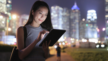 Canvas Print - Woman using tablet computer at night