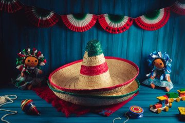 High contrast image of mexican hats and a serape on a wooden background