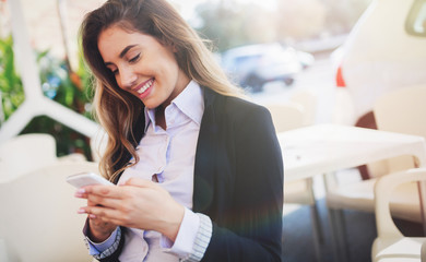 Beautiful woman using cellphone to text