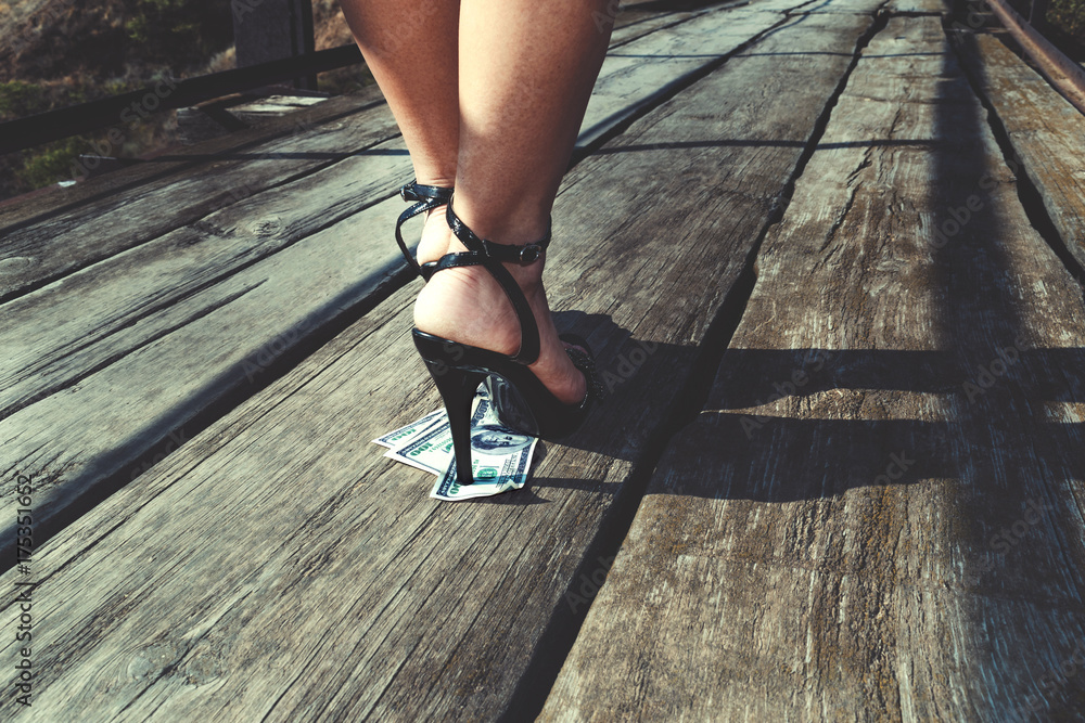 Beautiful girl in expensive shoes with a heel steps onto a stack of ...