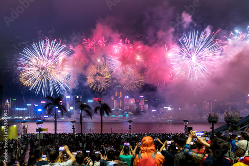 The crowd watching national day fireworks display in rain at waterfront of Victo Poster