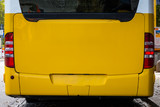 Fototapeta Miasto - Bright Yellow Bus Behind Empty Mockup Advertising Space Public Transportation Vehicle Close Up