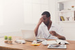 © Prostock-studio - Tired african-american employee in office, work with laptop