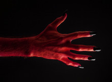 Red Devil Creepy Halloween Hand On A Black Background