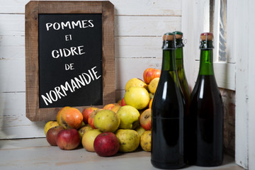 Wall Mural - organic fresh apples and bottle of Normandy cider with chalkboard