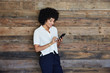 © trinettereed/Stocksy - Millennial businesswoman looking at phone in office