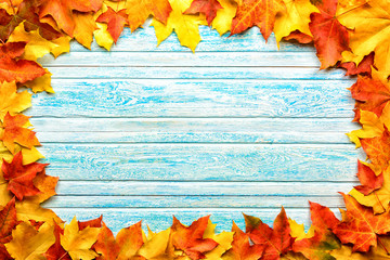 fallen leaves on wooden background, top view, copy space