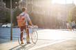 © JovoJVNVC/Stocksy - Man standing next to his bicycle waiting to go across the street