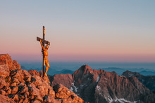 Summit Cross With Jesus Christ On A Mountain Summit At Sunrise