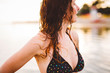 © goodvibrations/Stocksy - Woman in bikini at sunset