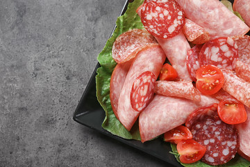 Poster - Plate with delicious sliced sausages on table