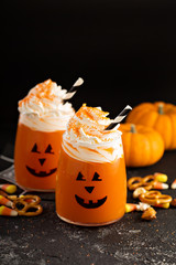 Halloween cold cocktail or drink with jack o'lantern face