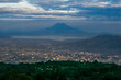 The city of San Salvador, El Salvador at sunset with the view of lake Ilopango and San Vicente Volcano, taken from San Salvador volcano