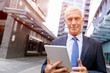© Sergey Nivens - Senior businessman holding touchpad