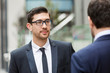 © Sergey Nivens - Two businessmen talking outdoors