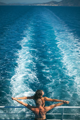 Wall Mural - couple embracing and kissing at the beach in late summer at dusk. Couple in love. Holidays. Fashion.