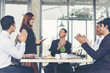 © aFotostock - Business Partners clapping hands to a success business woman after complete a deal.