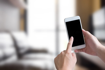 smartphone on woman hand  in living room.