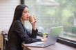 Beautiful Asian Woman using Laptop for Work at cafe, Attractive Woman work at office Concept.