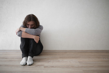 Wall Mural - upset woman near  wall,depression and loneliness