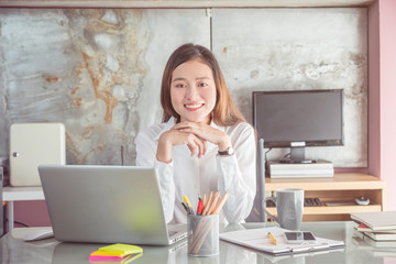 Wall Mural - Young asian beautiful businesswoman wearing white shirt smiling at working office