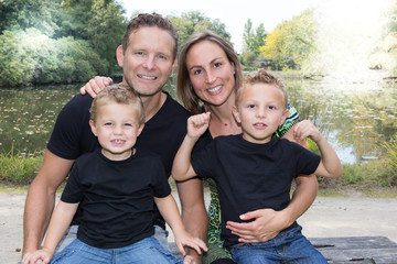 beautiful young caucasian family outdoors looking at the camera