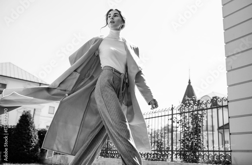 Fotografie, Tablou young beautiful stylish woman walking in street in blue coat, autumn fashion trend, smiling, happy