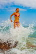 © 777Aleksey - young and beautiful girl in colorful dress jumping in ocean water in sunset splash fresh movement