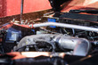 Washing car engine with water nozzle in selective focus. Small depth of field