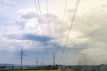 a high voltage power pylons against clouds