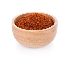 Wall Mural - Pile of red paprika powder in wooden bowl on white background