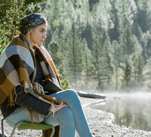 Woman Sitting Near Lake In Morning