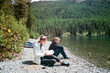 © Milles Studio/Stocksy - People sitting near lake