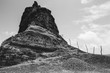© Lawrence del Mundo/Stocksy - Interesting rock formation and land mass in black and white