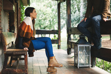 Couple Sitting In The Porch Of A Rural Home.