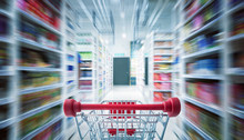 Red Shopping Cart With Motion Speed Blurred .supermarket Aisle Background .