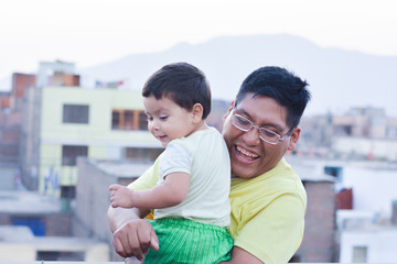 Happy latin family - daddy with his toddler son playing