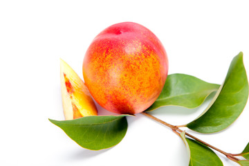 fresh peach fruits with green leaves isolated on white background